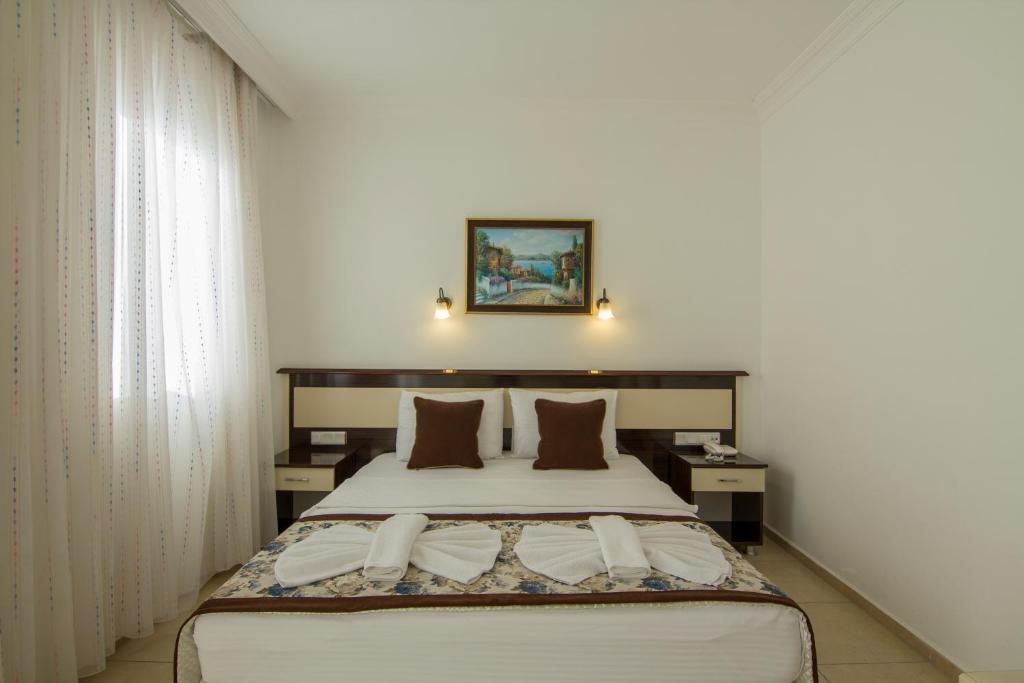 Postel nebo postele na pokoji v ubytování Belcekum Beach Hotel