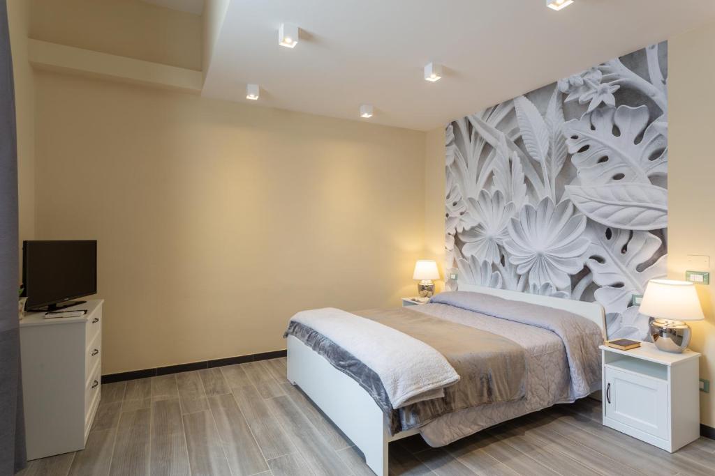 Postel nebo postele na pokoji v ubytování Le stanze di Carla! Bagno privato, cucina in comune