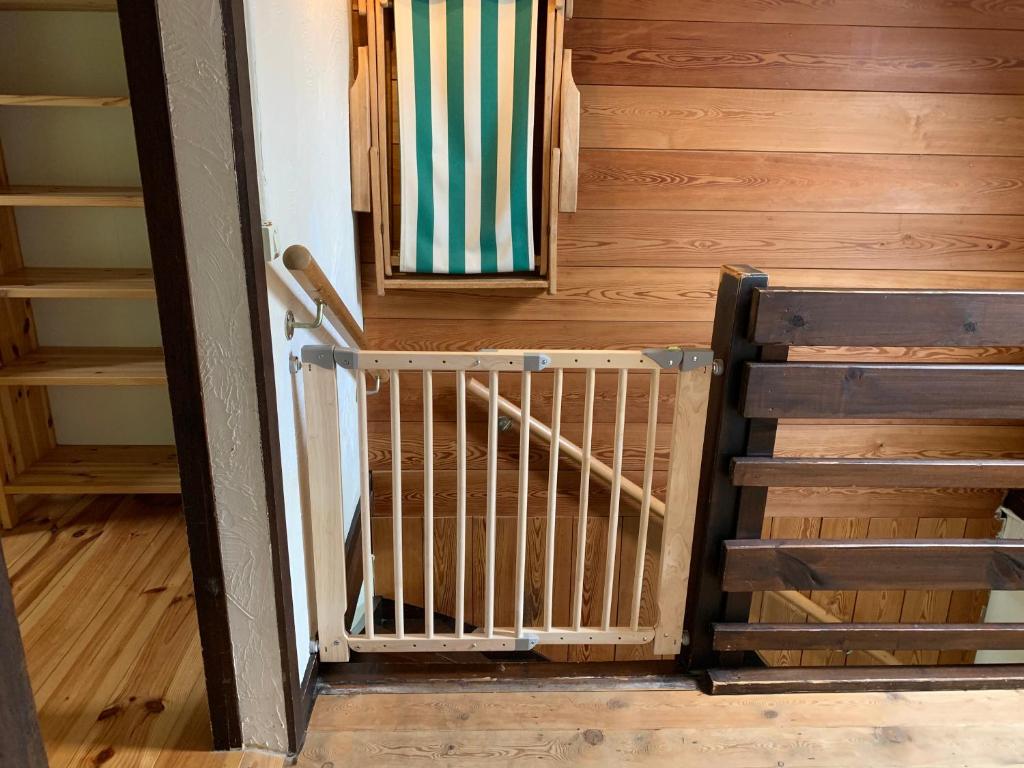 a staircase in a room with wooden walls and wooden floors at Ysermonde Fisherman's Cottage in Nieuwpoort