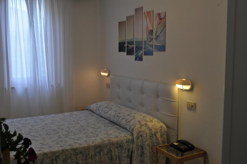 Postel nebo postele na pokoji v ubytování Hotel Giardino