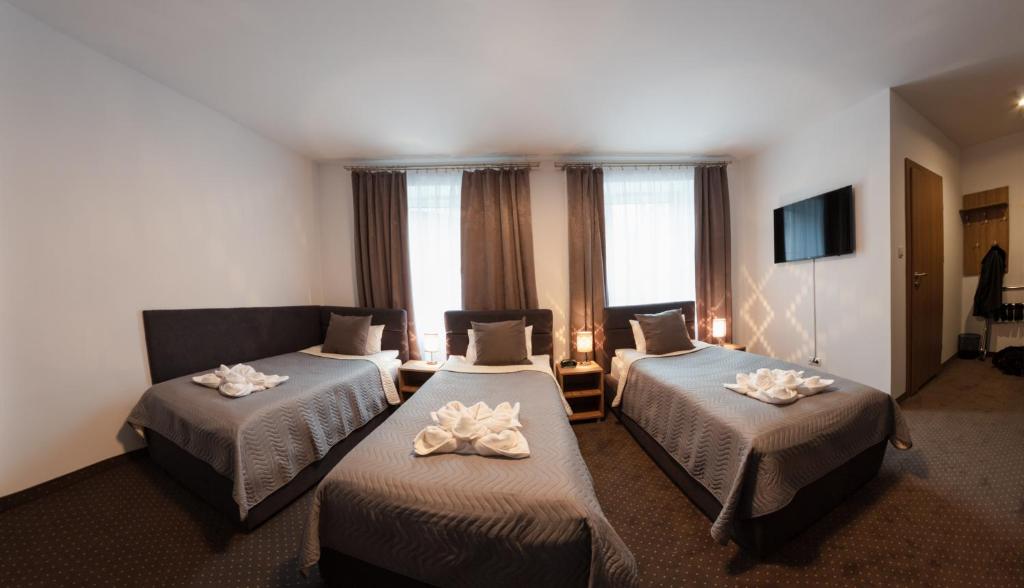 מיטה או מיטות בחדר ב-HOTEL LUBLIN