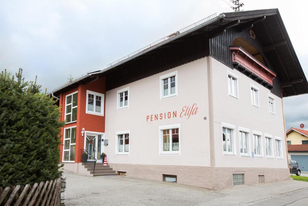 a large white building with the name of the building at Pension Elisa in Lechbruck