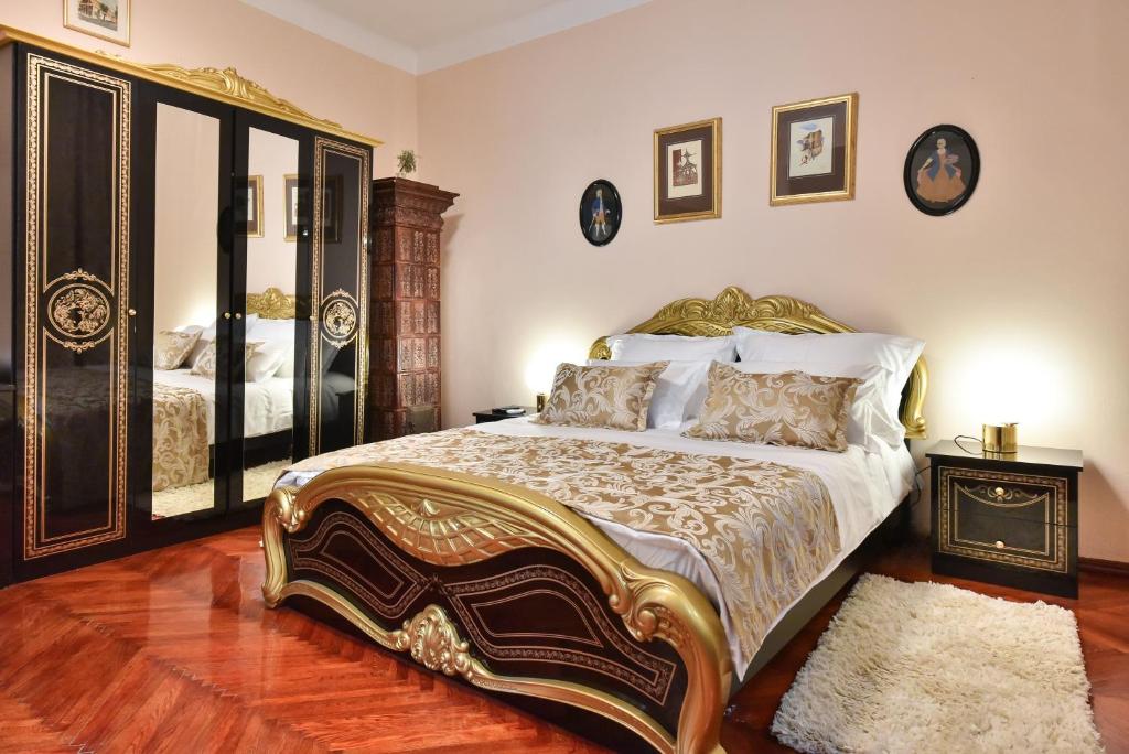 a bedroom with a large bed and a mirror at Old Town Jacuzzi Suite in Zadar