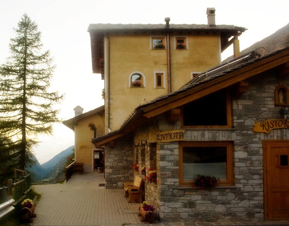 a building with a store on the side of it at Locanda Lac Place Moulin in Bionaz