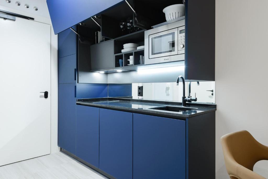 Kuchyň nebo kuchyňský kout v ubytování Smartrental Collection Gran Vía Centric