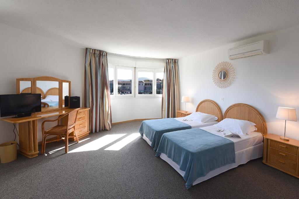 Postel nebo postele na pokoji v ubytování Hotel Le Tilbury