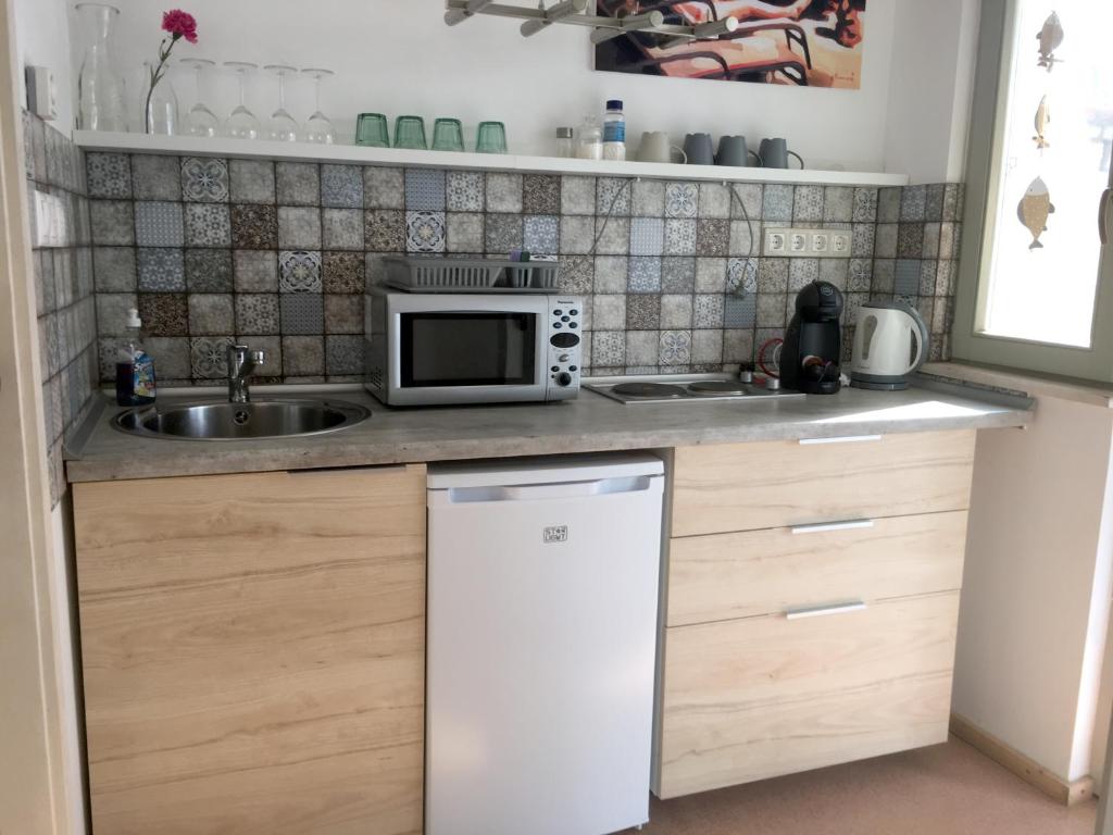 Kuchyň nebo kuchyňský kout v ubytování Szélrózsa apartmanház