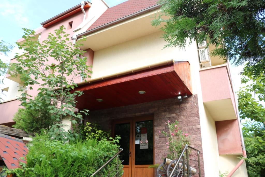 a house with a red awning on it at семеен хотел Визаж in Yambol