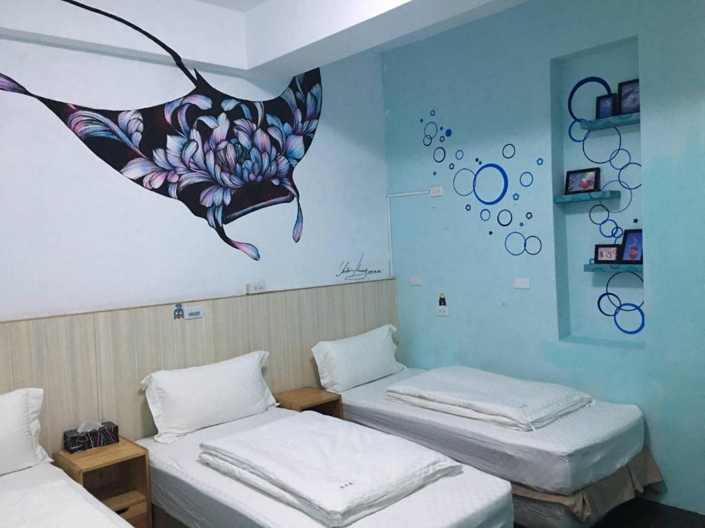 A bed or beds in a room at Light Blue Hostel