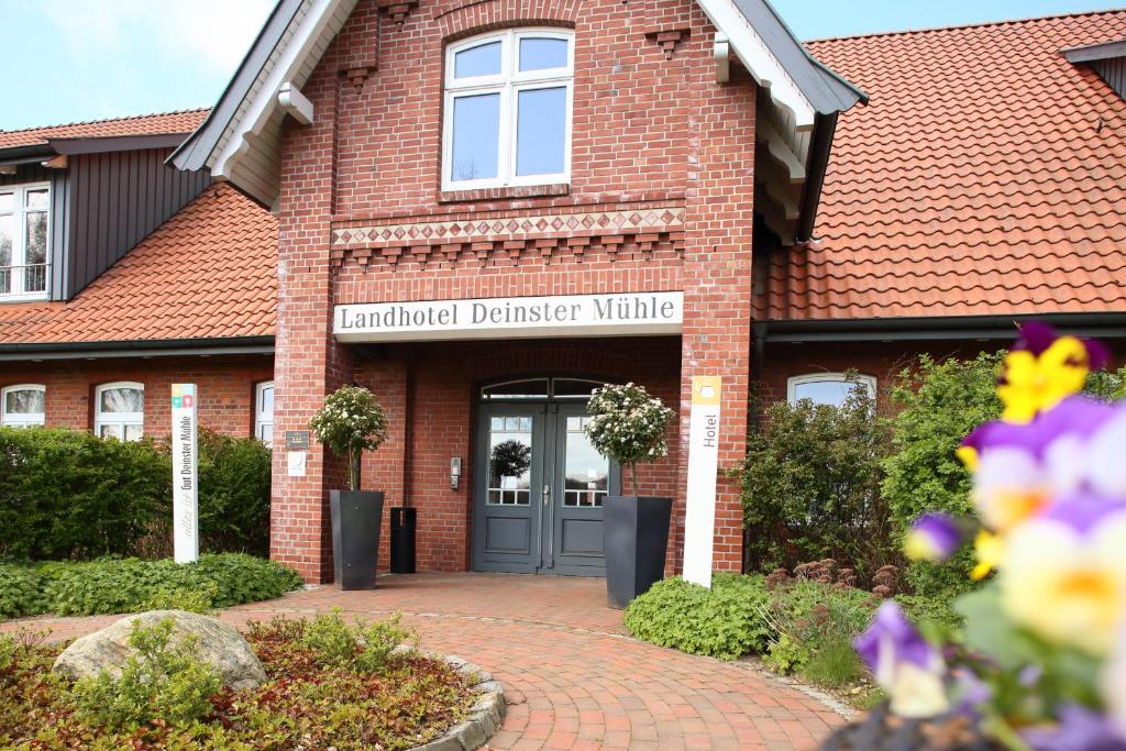 a brick building with a sign that readsauthorized district nursing at STADE LAND GOLF HOTEL Tiny Häuser in Deinste