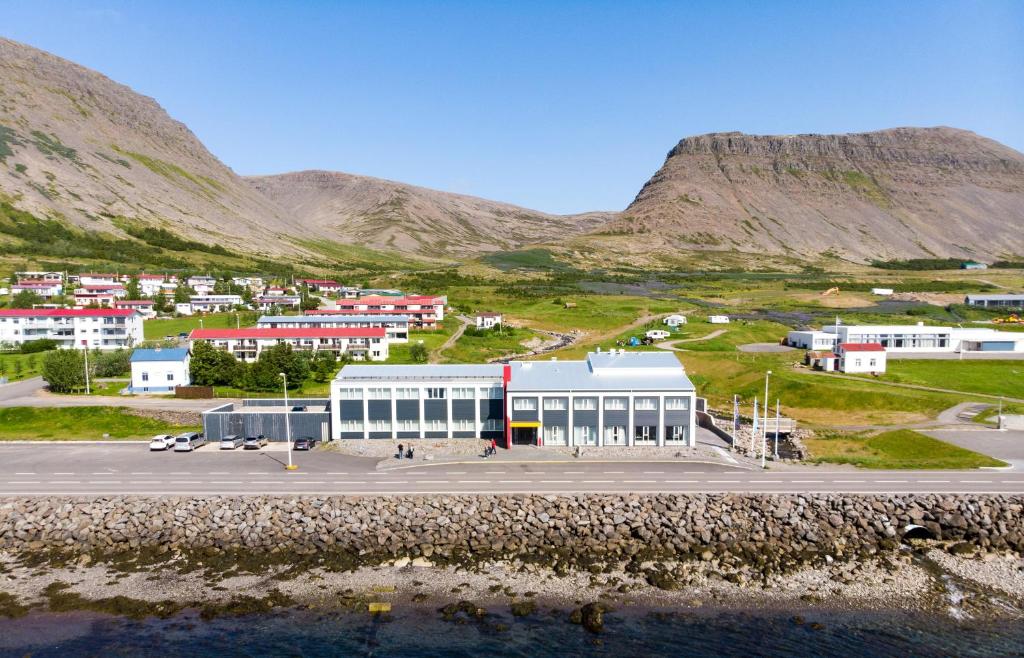 a large building in the middle of a mountain at Fosshotel Westfjords in Patreksfjörður