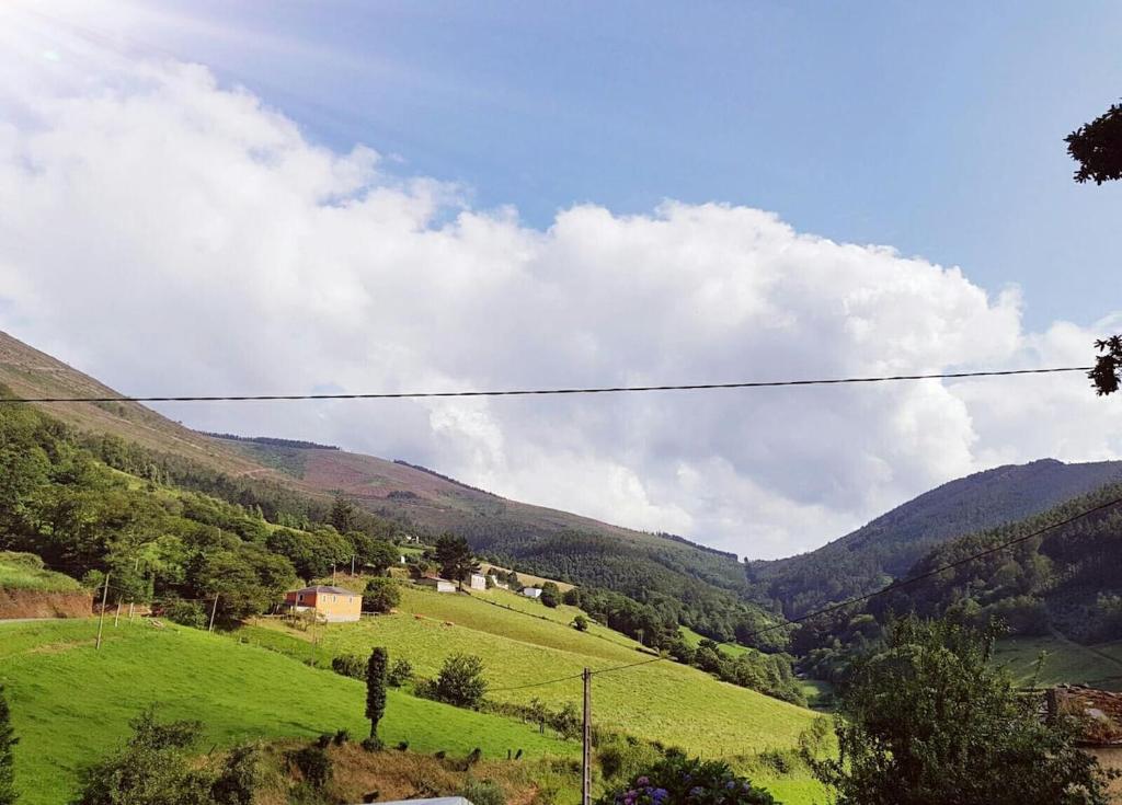 a view of a green valley with mountains at Casa de aldea Amezaga in Taramundi