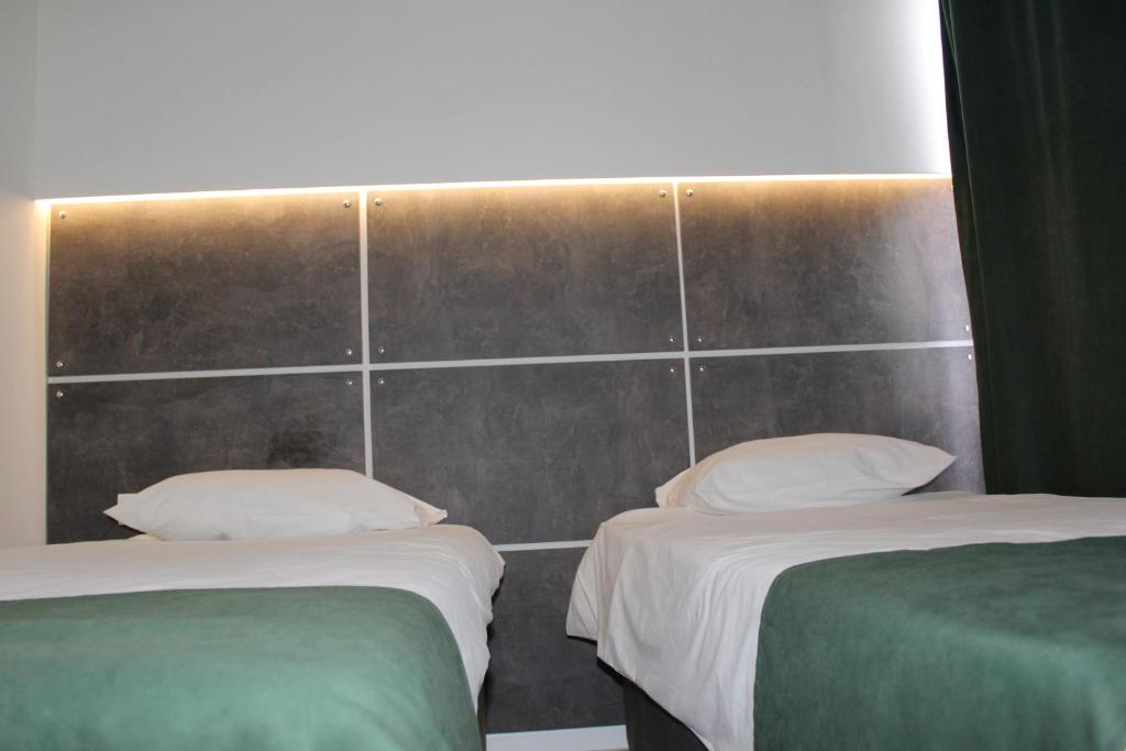 Postel nebo postele na pokoji v ubytování Hotel Grand