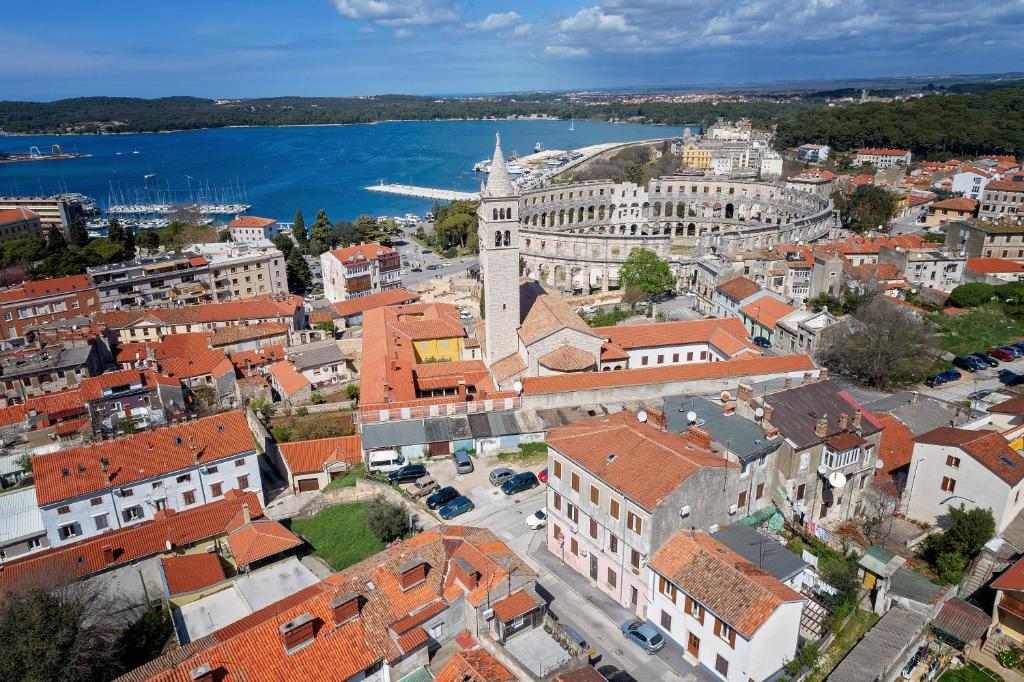 an aerial view of a city with buildings and the water at Apartment Arena in Pula