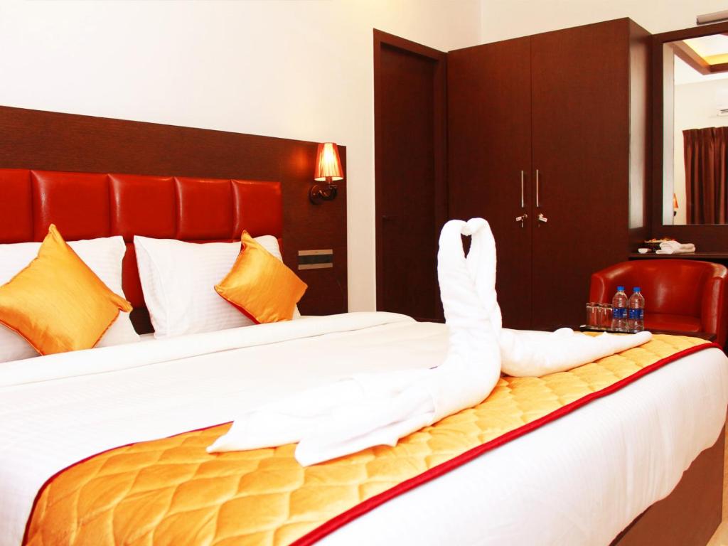 Postel nebo postele na pokoji v ubytování Staylite Suites