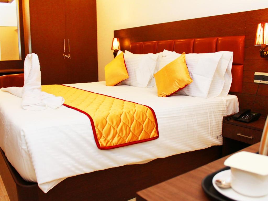 Postel nebo postele na pokoji v ubytování Staylite Suites