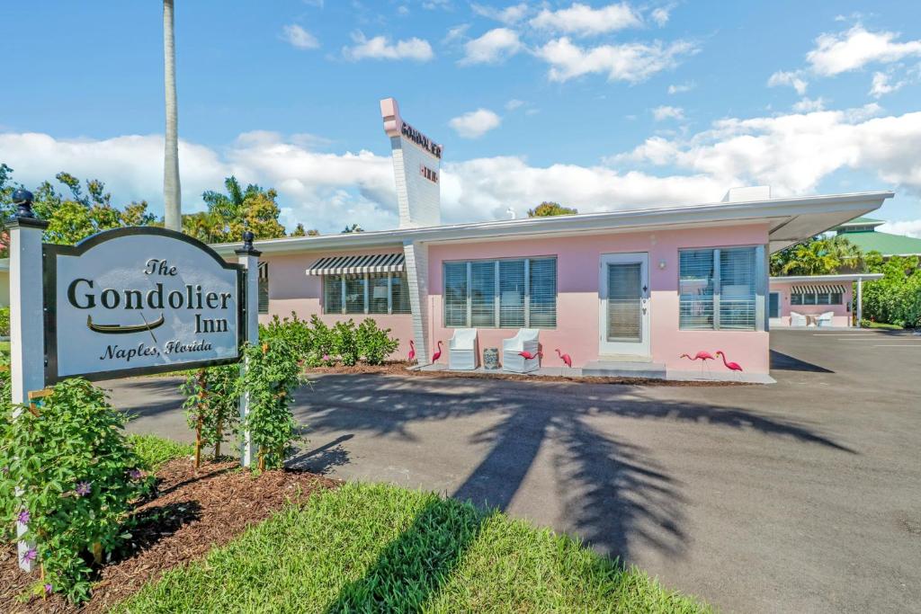 a pink building with a sign in front of it at The Gondolier Inn in Naples