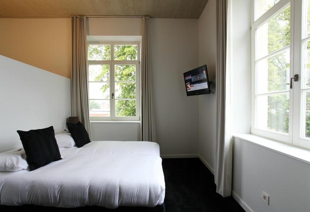 Postel nebo postele na pokoji v ubytování Hotel The Lodge Vilvoorde