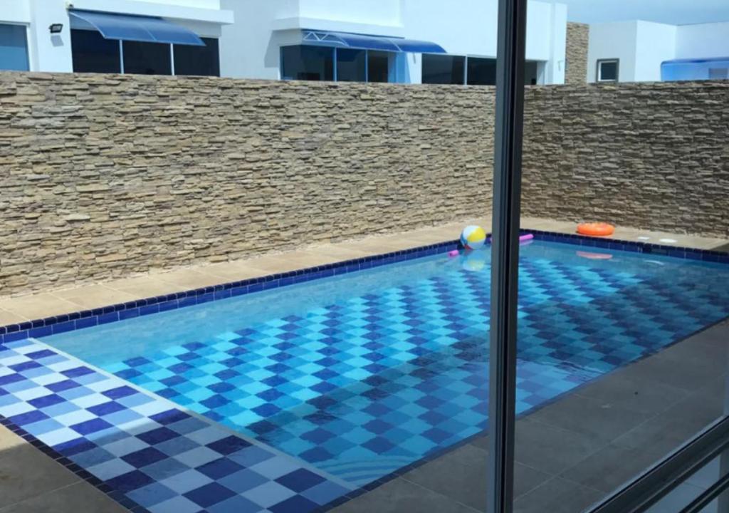 una piscina con suelo de color azul y negro a cuadros en Casa Quinta con Piscina Privada y Aire Acondicionado via a Girardot, en Flandes