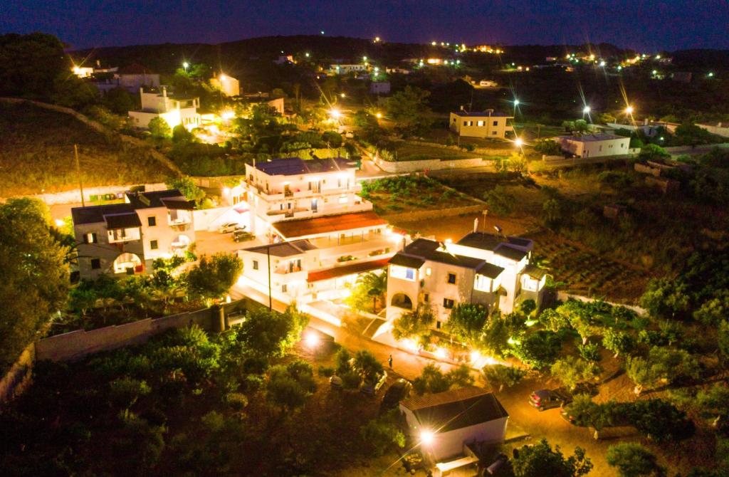 a view of a town at night with lights at Theofilos Appartements in Livadi