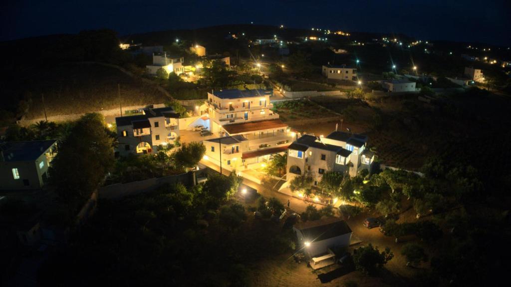 a group of buildings at night with lights at Theofilos Appartements in Livadi