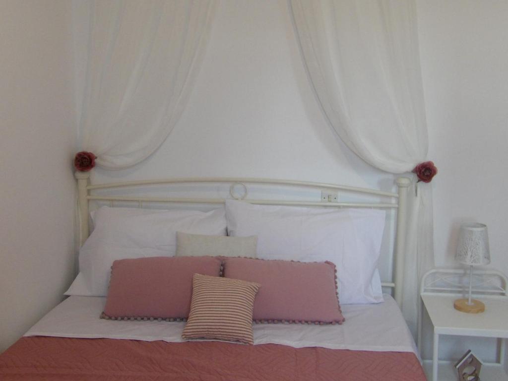 a bedroom with a white bed with a white canopy at Teo 3 in Gouves