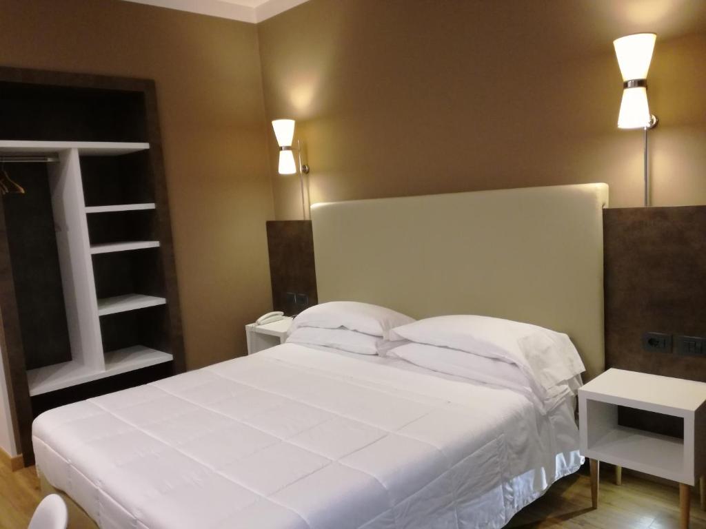 Postel nebo postele na pokoji v ubytování Hotel Umbria