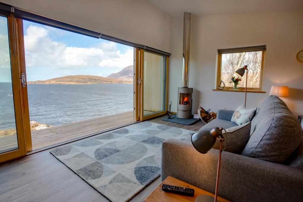 a living room with a couch and a view of the ocean at Tigh na Mara in Ullapool