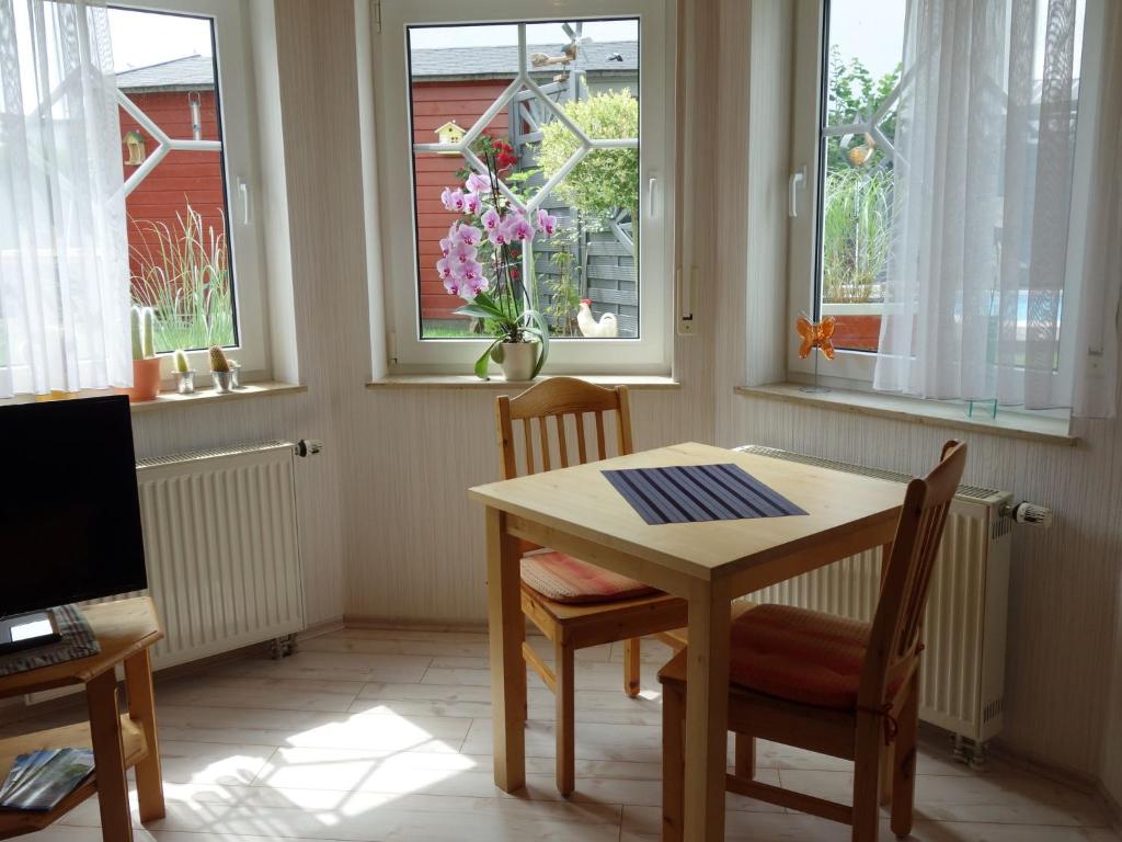 a dining room with a table and chairs and windows at Apartment with private terrace in Runkel in Ennerich