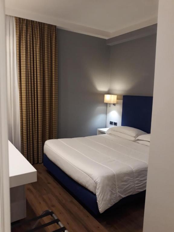 Postel nebo postele na pokoji v ubytování Hotel Umbria