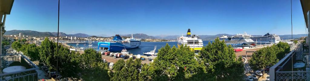 a harbor with several ships docked in the water at Hotel le Dauphin in Ajaccio