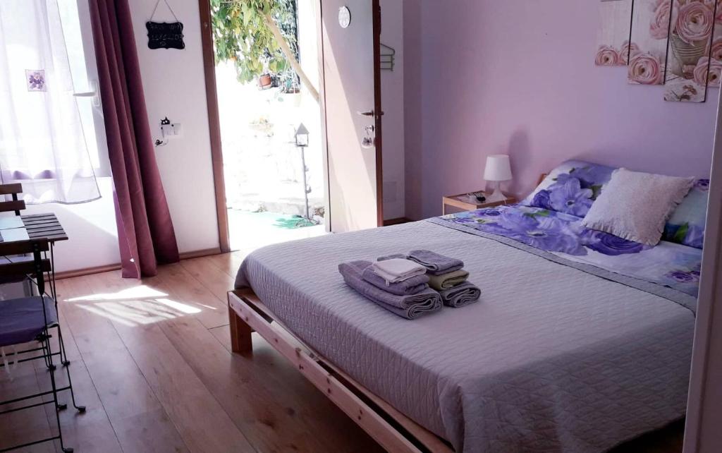 a bedroom with a bed with two bags on it at Dependance Miluna in Nettuno