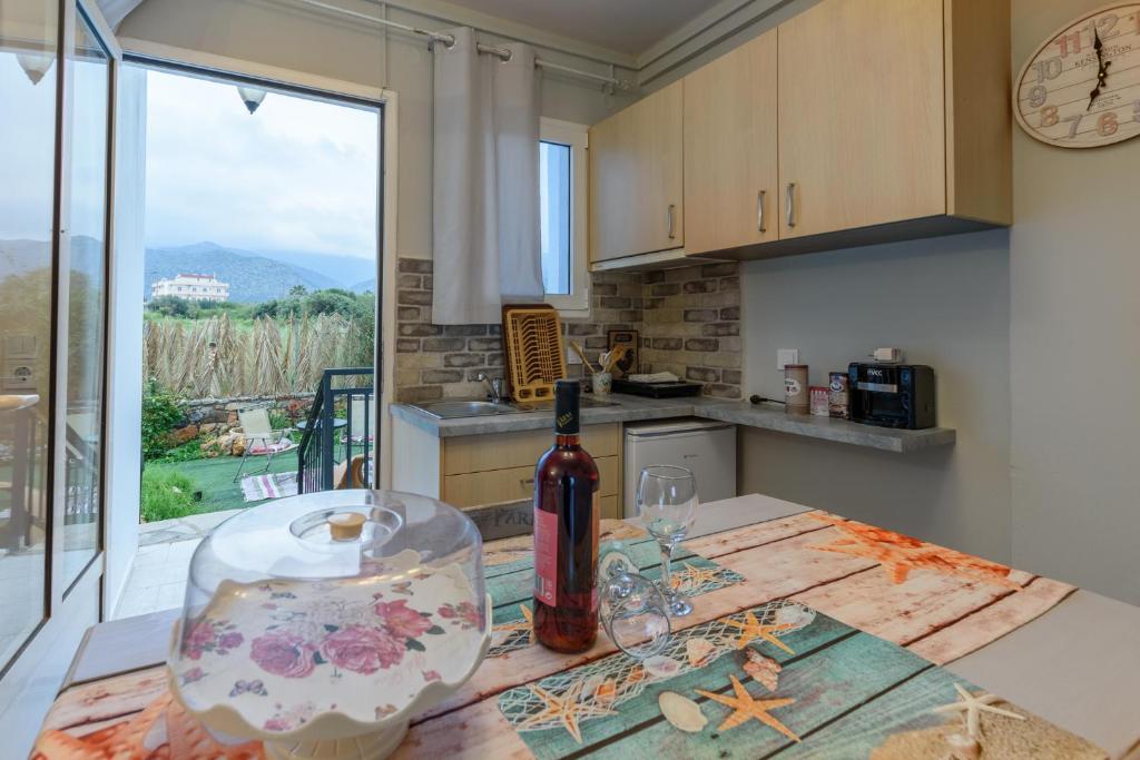 a bottle of wine sitting on a table in a kitchen at Olympus Studios in Malia