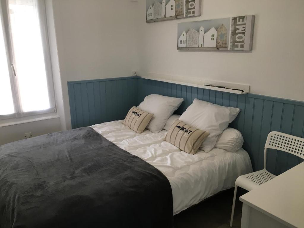 a bedroom with a bed with two pillows on it at Gîte du Petit Poucet in Saint-Hilaire-de-Riez