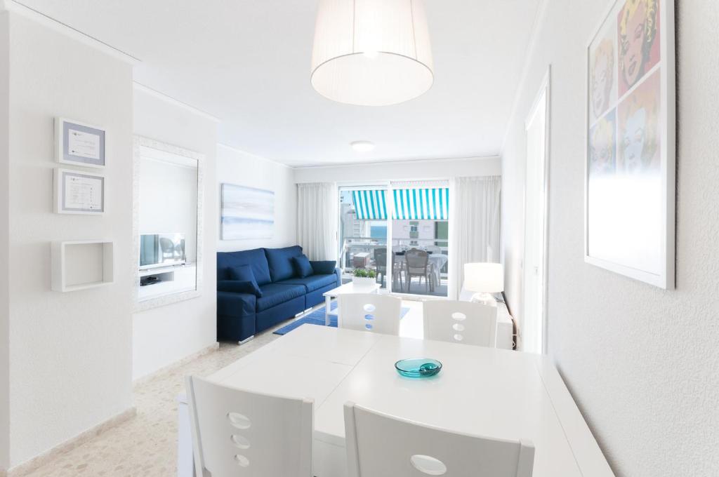 a white living room with a white table and chairs at AG FLORIDA in Playa de Gandia