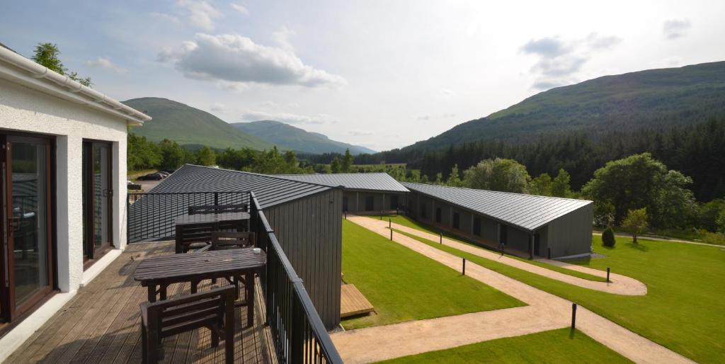 a balcony of a house with a view of the mountains at Bridge of Orchy Hotel in Bridge of Orchy