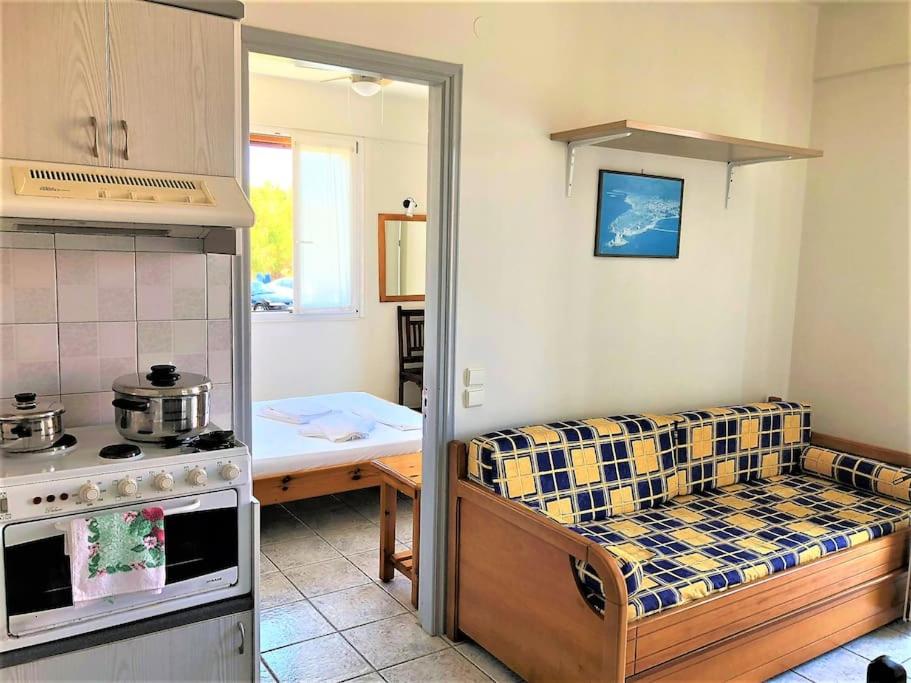 a kitchen with a couch and a table in a room at Mythos Suites-Apollo apartment in Methoni