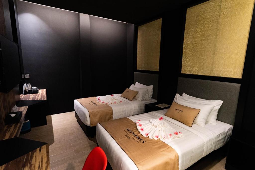 Postel nebo postele na pokoji v ubytování Artworks Hotel Ipoh