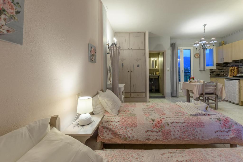 a bedroom with a bed and a living room at Olympus Studios in Malia