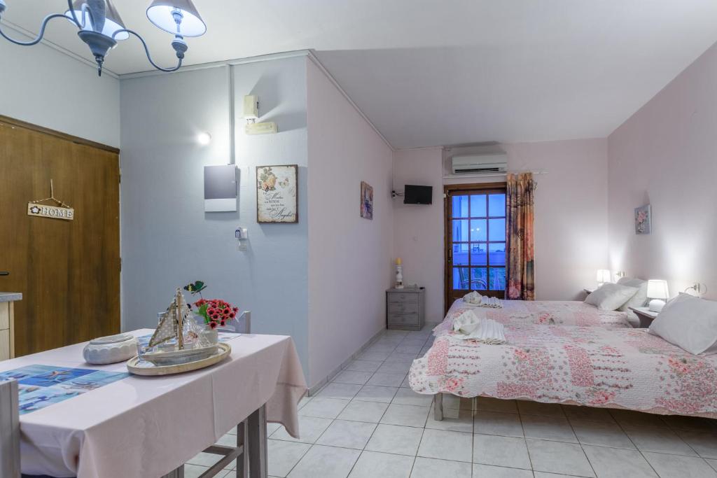 a bedroom with a bed and a table in it at Olympus Studios in Malia