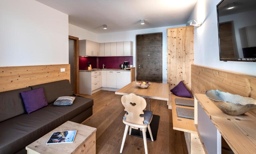 a living room with a couch and a table and a kitchen at Apartment 39012 in Merano
