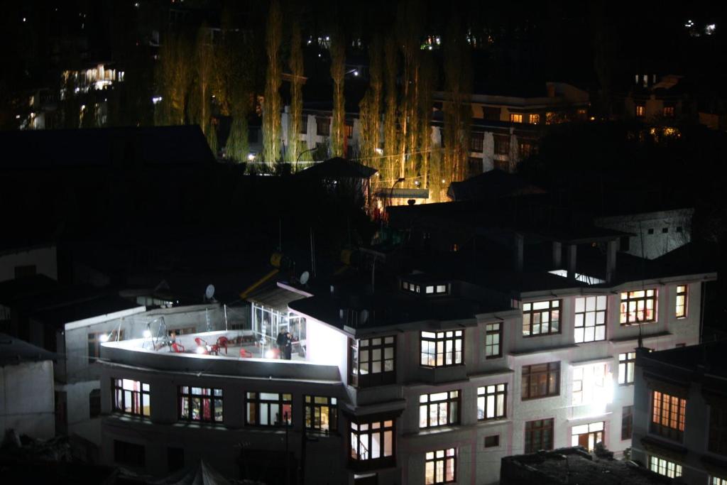 a night view of a building with lights at Hotel Khan Manzil in Leh