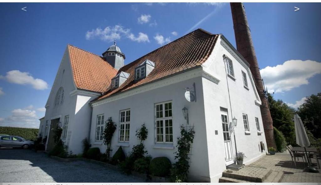 a white house with a lighthouse on top of it at Tåning Gl. Mejeri in Skanderborg