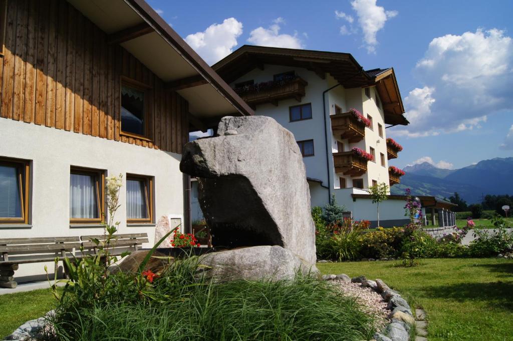 a large rock sitting in front of a building at Ferienhaus Spieljochblick in Uderns