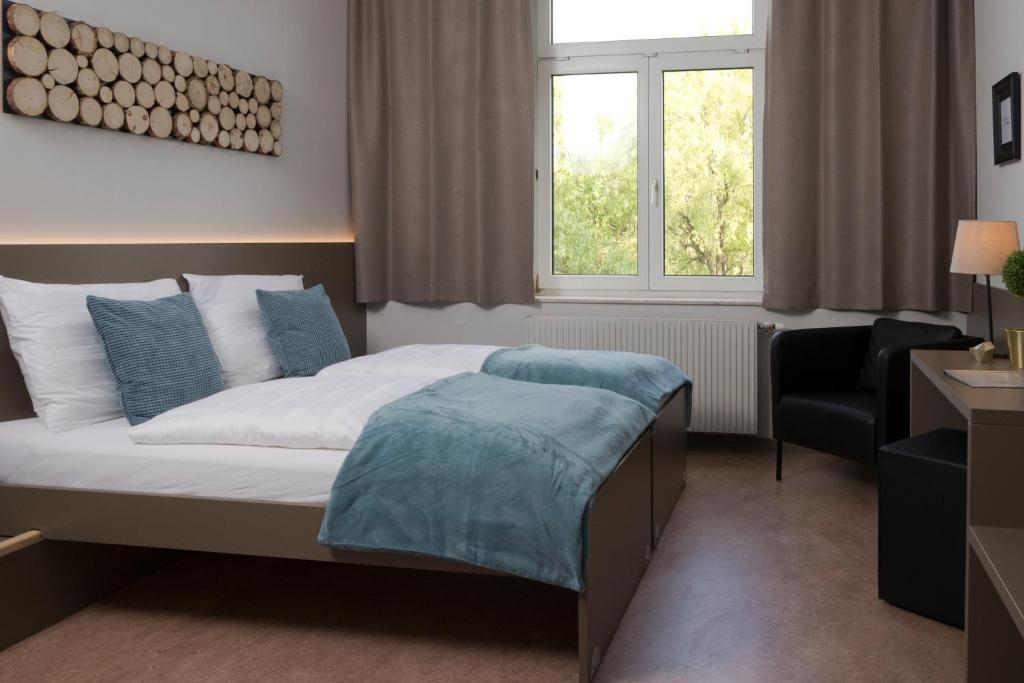 Postel nebo postele na pokoji v ubytování campus Horn