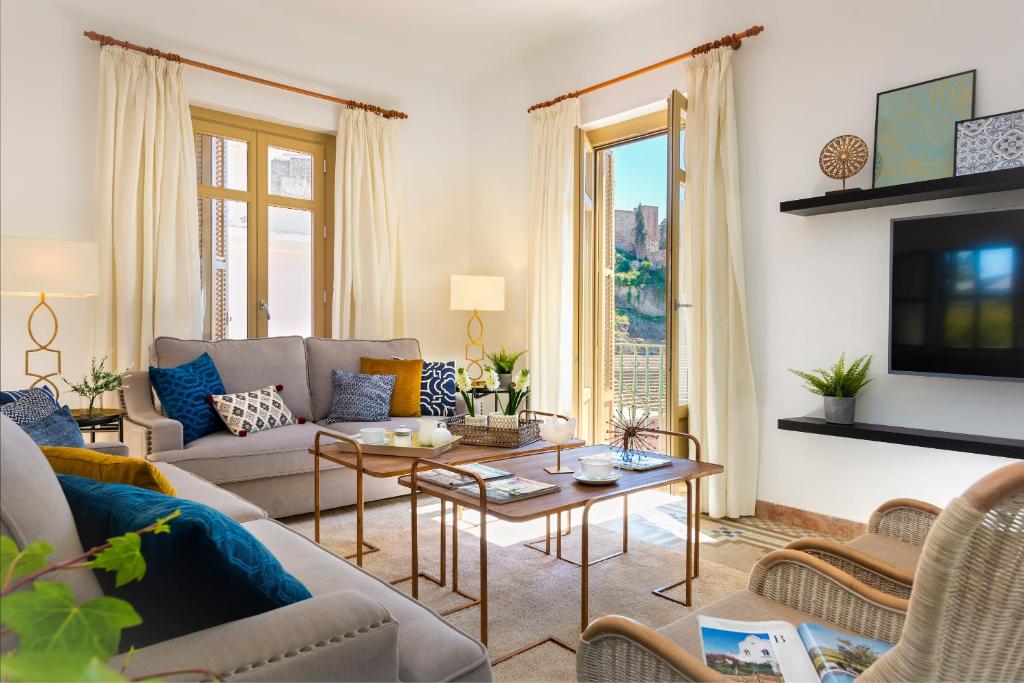 a living room with a couch and a table at Genteel Home Zegrí in Málaga