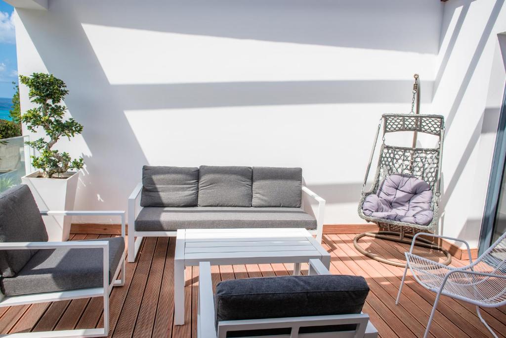 a living room with a couch and a chair at Julipapas Gardens in Paphos