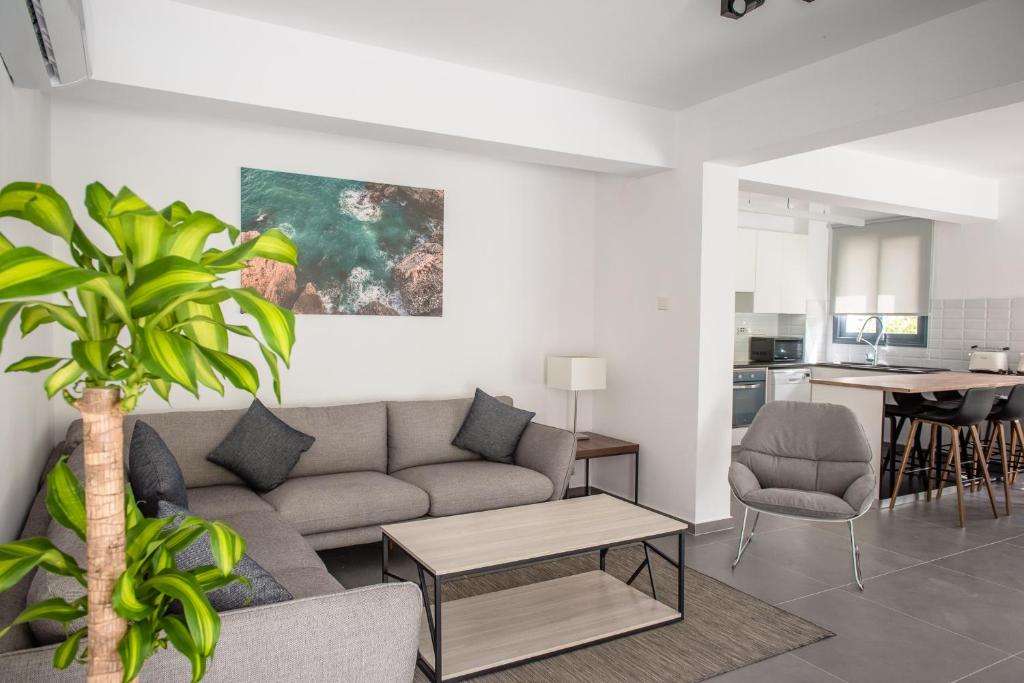 a living room with a couch and a table at Julipapas Gardens in Paphos