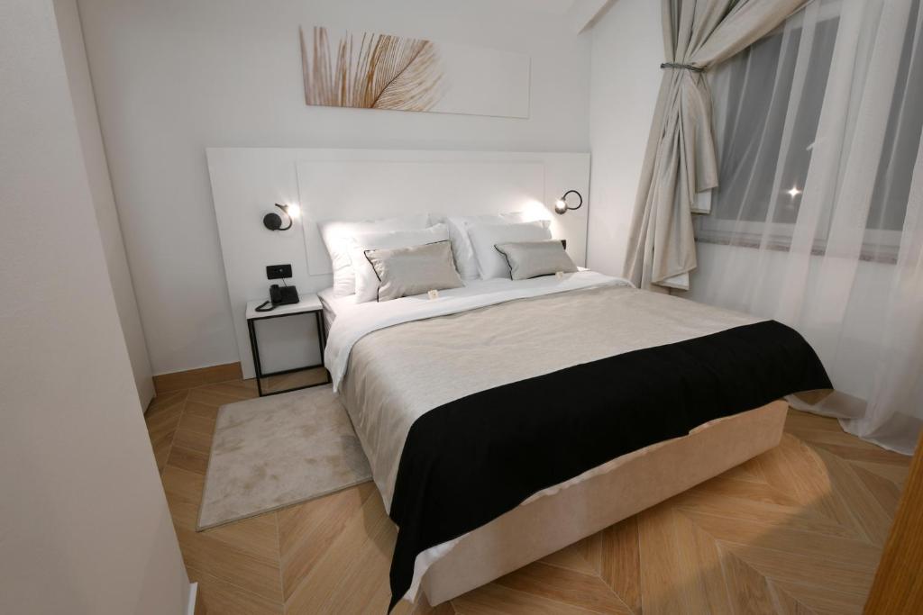 Postel nebo postele na pokoji v ubytování Aparthotel Milenij