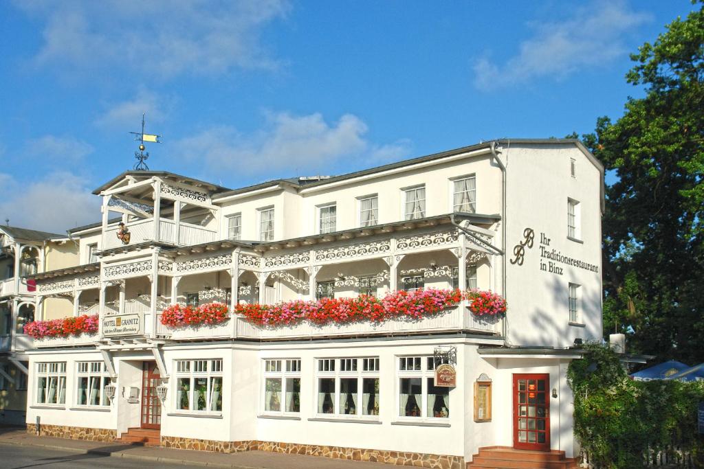 a white building with flowers on the front of it at Hotel Granitz in Binz